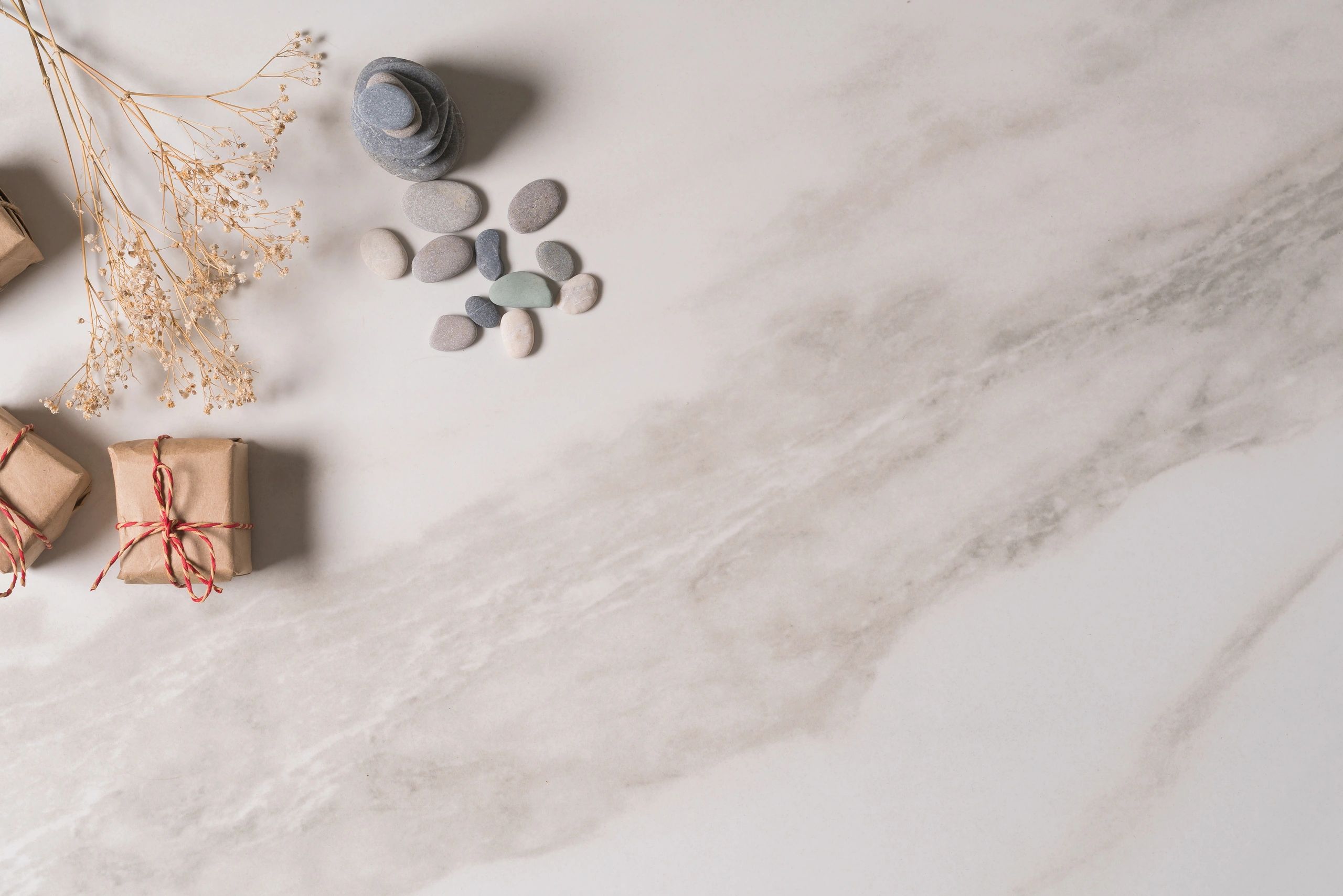 Minimal gift box and stones on marble