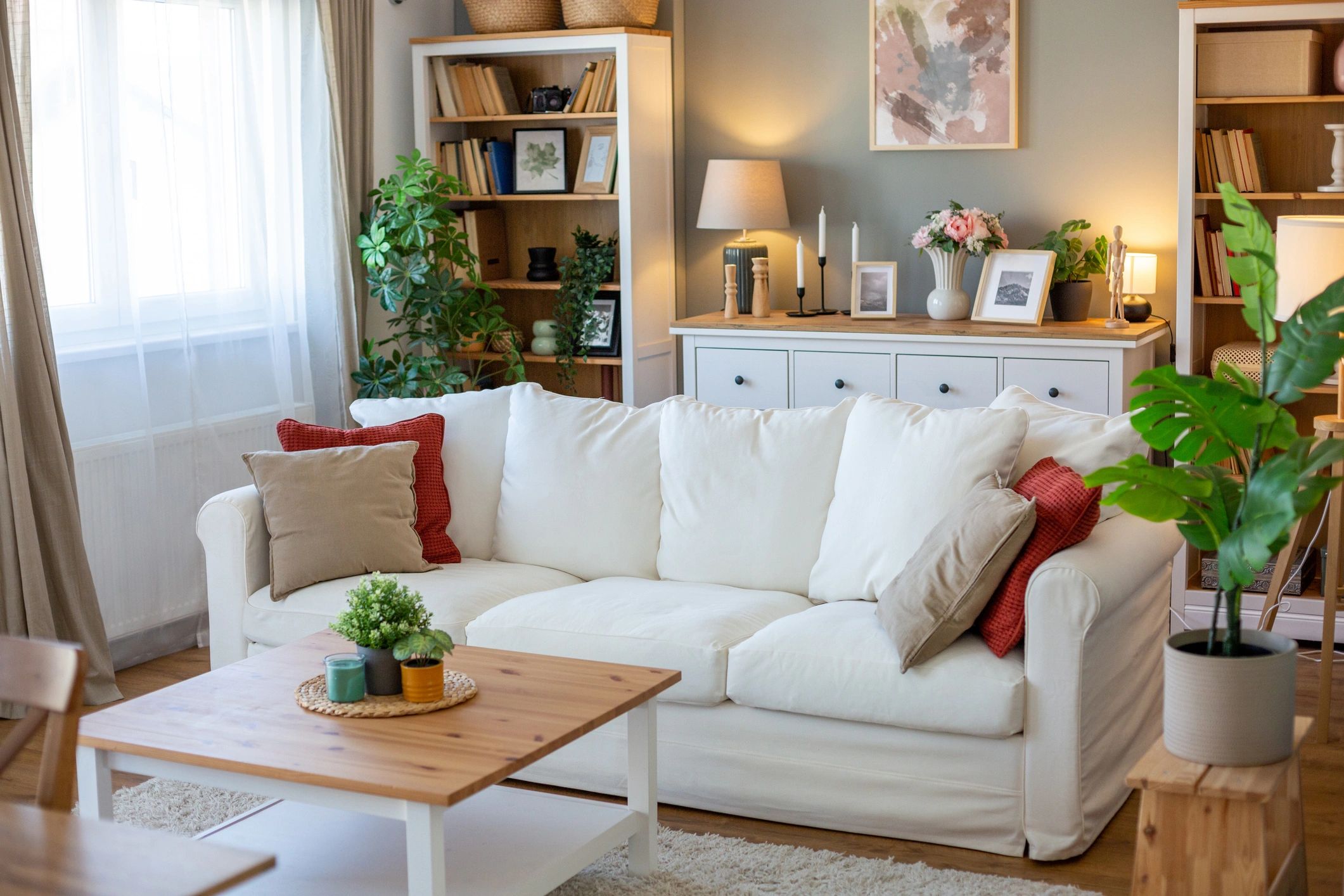 Bright minimal living room with white sofa and plants