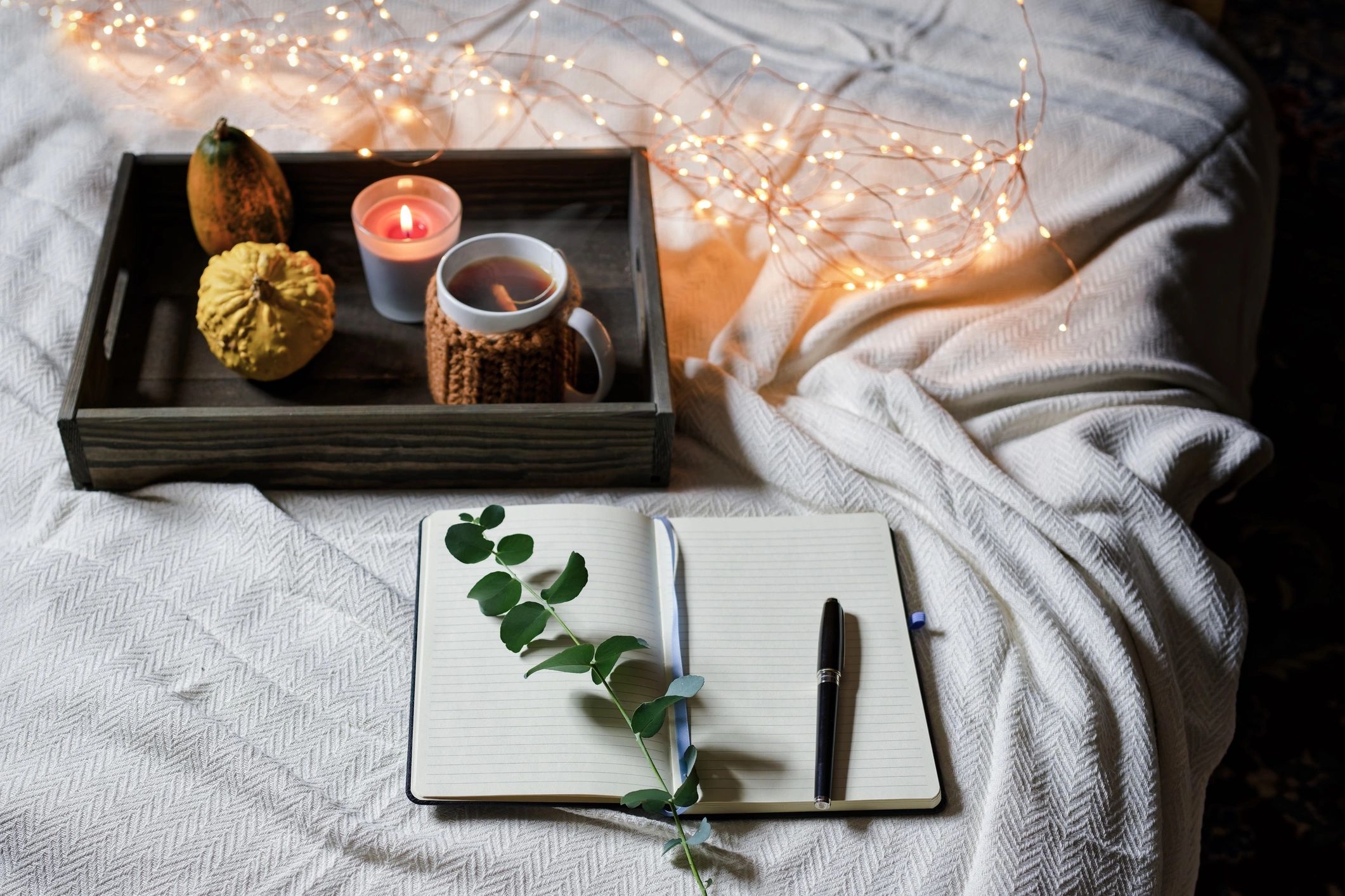 Cozy journaling setup with tea and candle